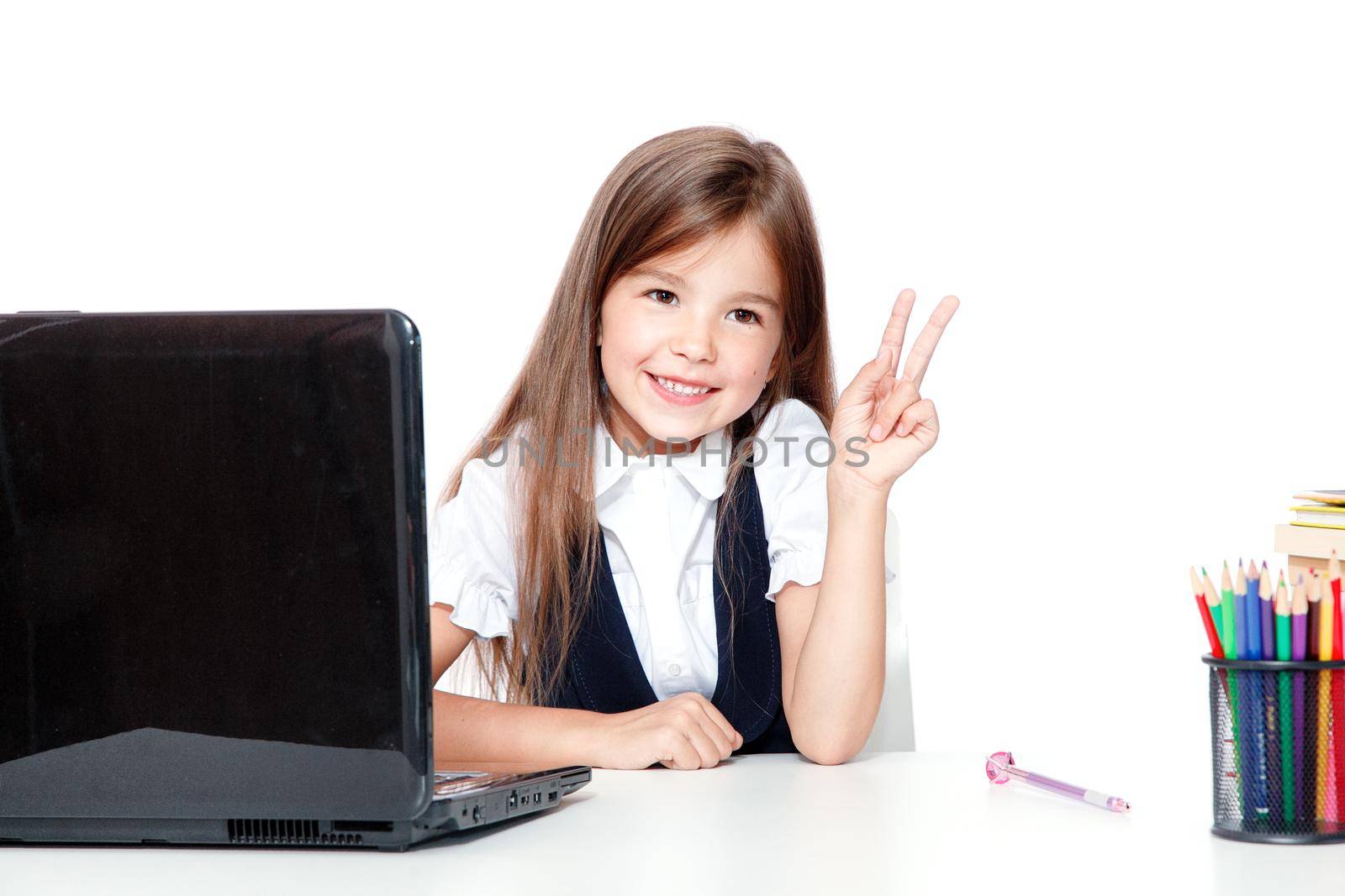 Happy and cute teen school girl sitting on laptop by Taut