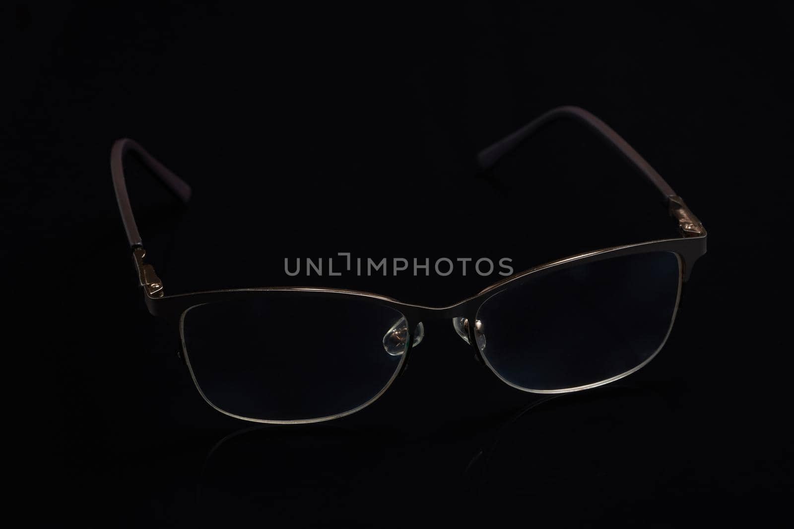 Glasses in fashionable frames on a black background. Close up