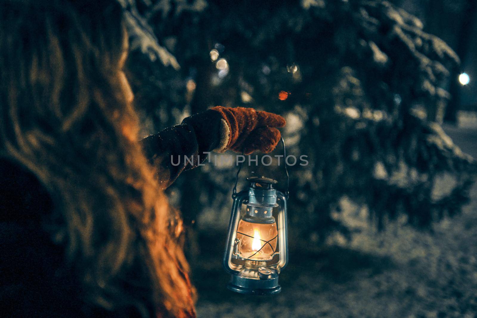 Young girl with lantern in winter forest fairy tale, book cover, christmas time, closeup