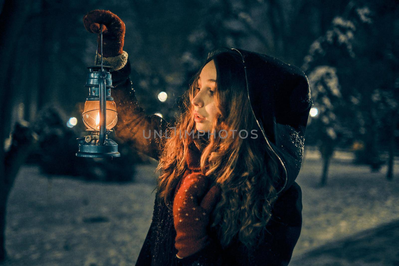 Young girl with lantern in winter forest fairy tale, book cover, christmas time