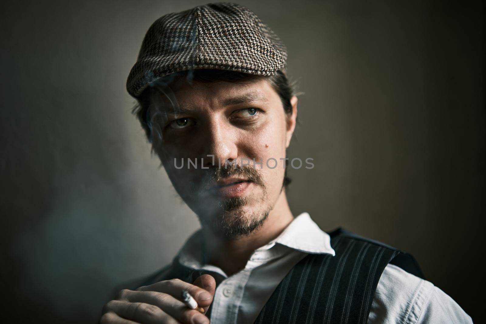Young guy smoke cigarette, blows smoke, dressed in a retro style, in a beret, cinematic shot, big closeup