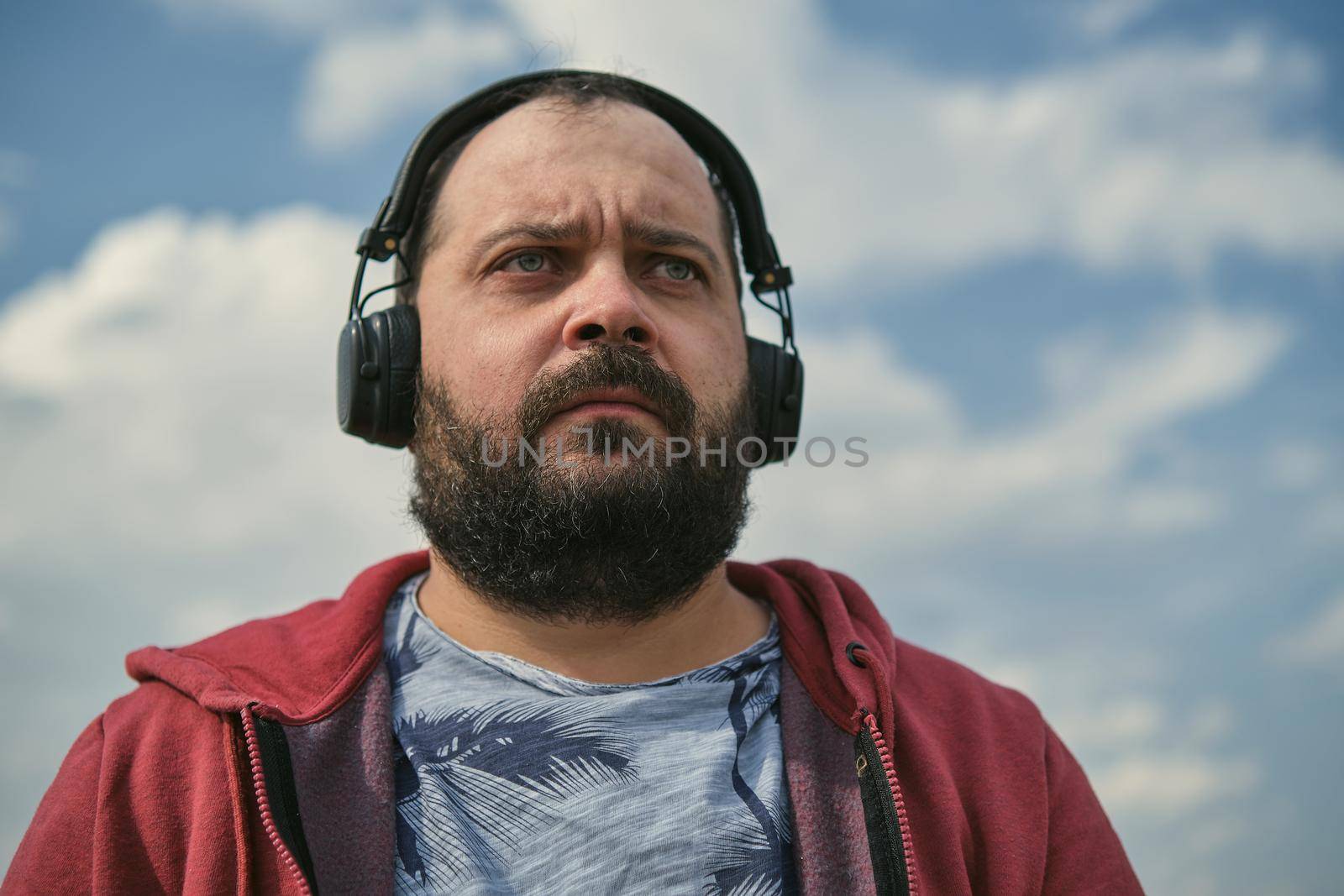 Middle aged man listening to music, close up by snep_photo