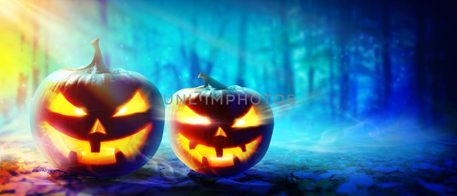 Close up view of scary Halloween pumpkin with eyes glowing inside by Taut