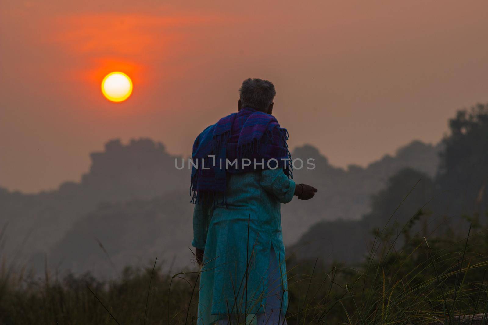 Rear view of a elder man looking at sunrise by snep_photo