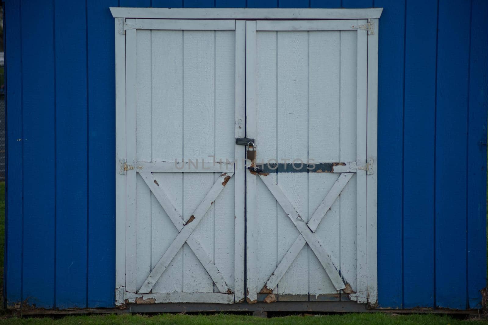 Blue wooden outdoor shed rustic double white closed doors by marysalen