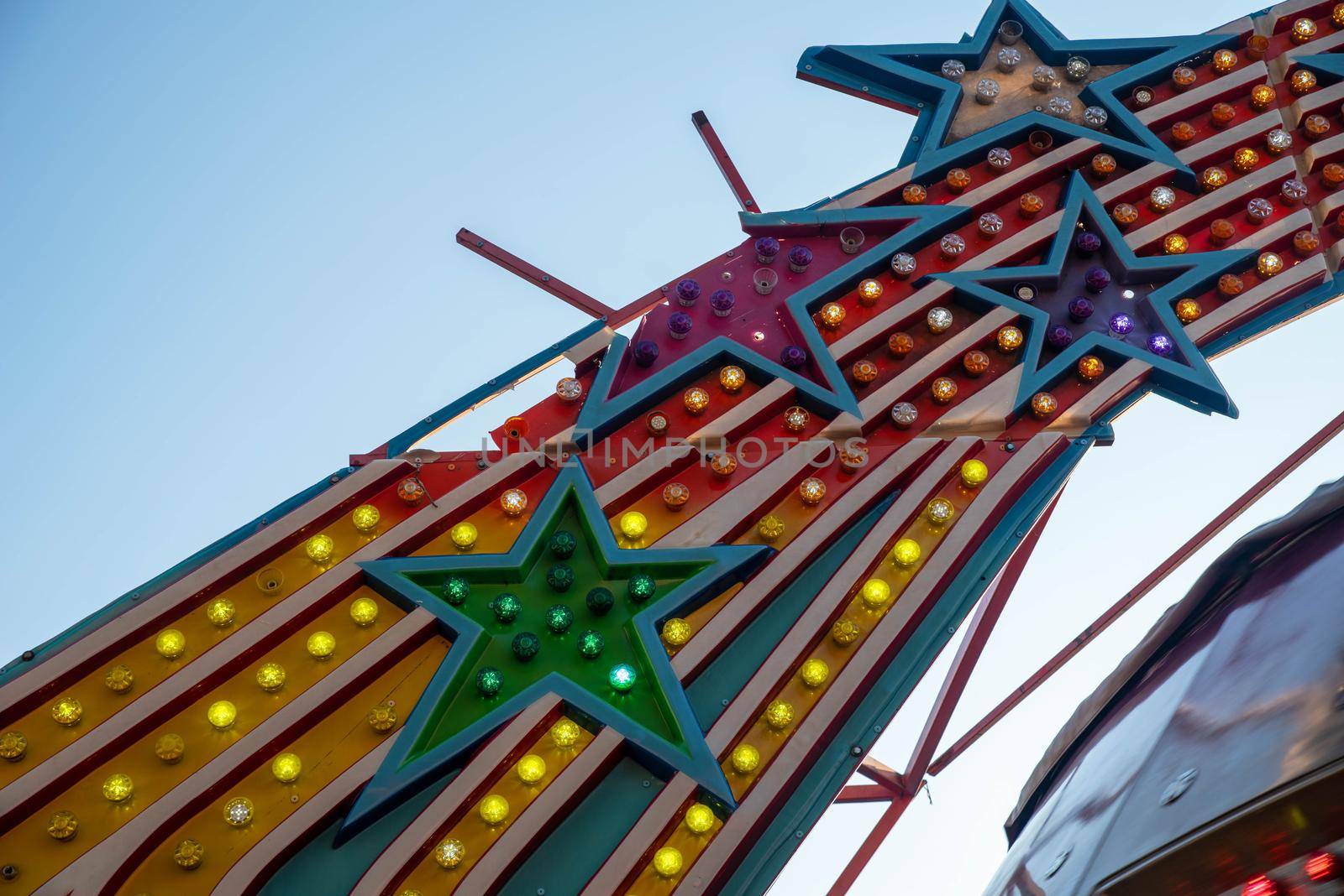Exciting colorful lights in shooting star patterns with broken stars and bright colors no people in this nostalgic country fair shot with copy space.