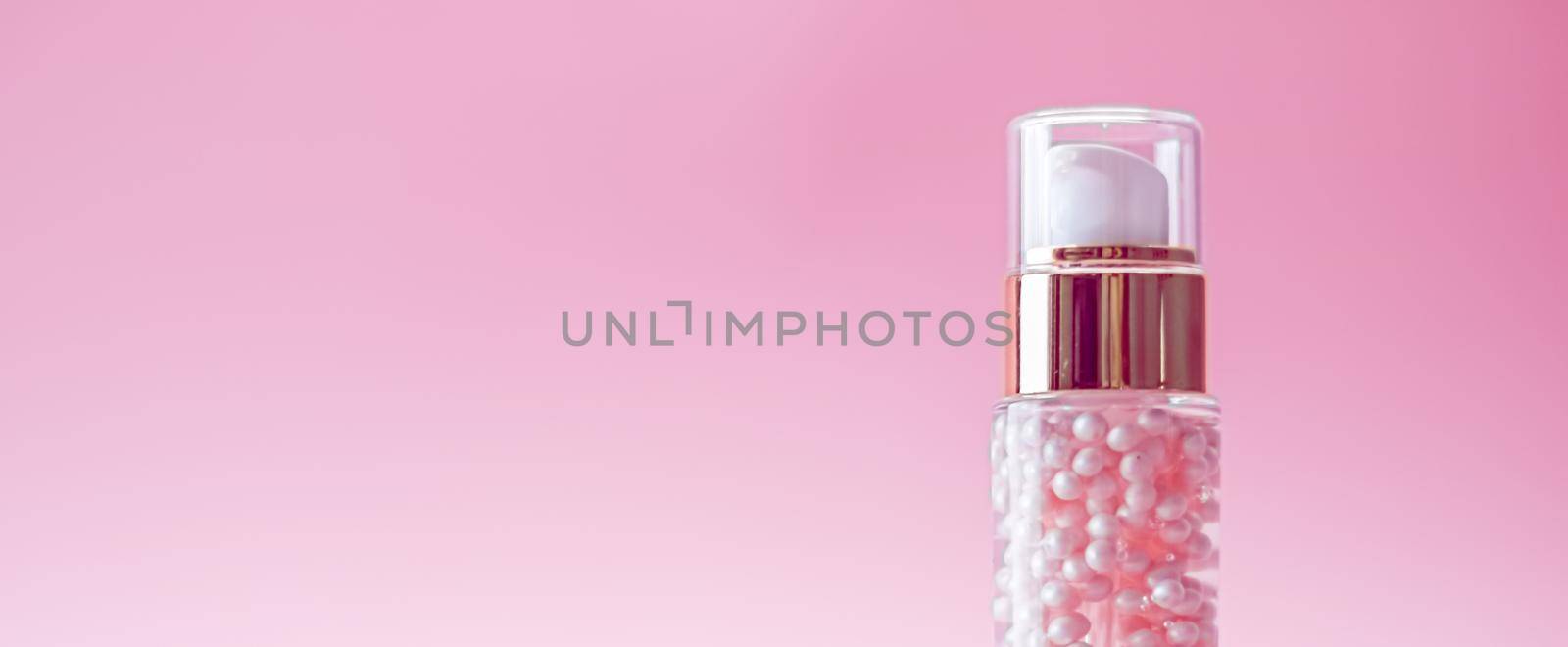 Skincare bottle on pink background, luxury beauty and cosmetic products.