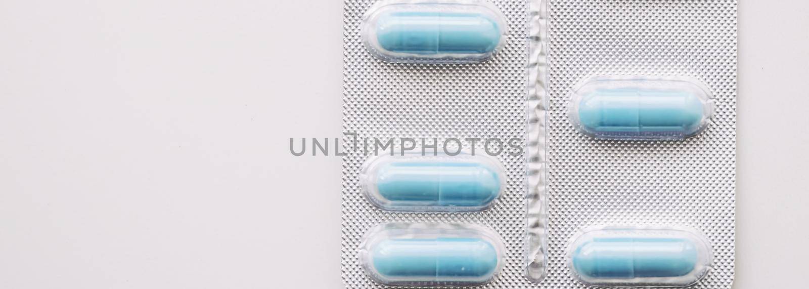 Blue pills and capsules as nutrition supplement, wellness and health care by Anneleven