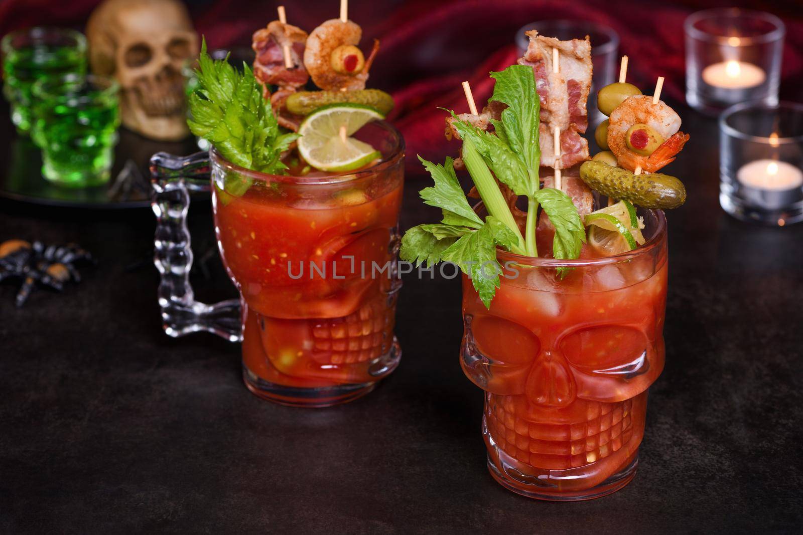 Creepy Halloween party - Caesar or Bloody Mary cocktail containing vodka, some tomato juice, different spices and flavorings, such as Worcestershire sauce, celery. Served with ice in a beer glass 