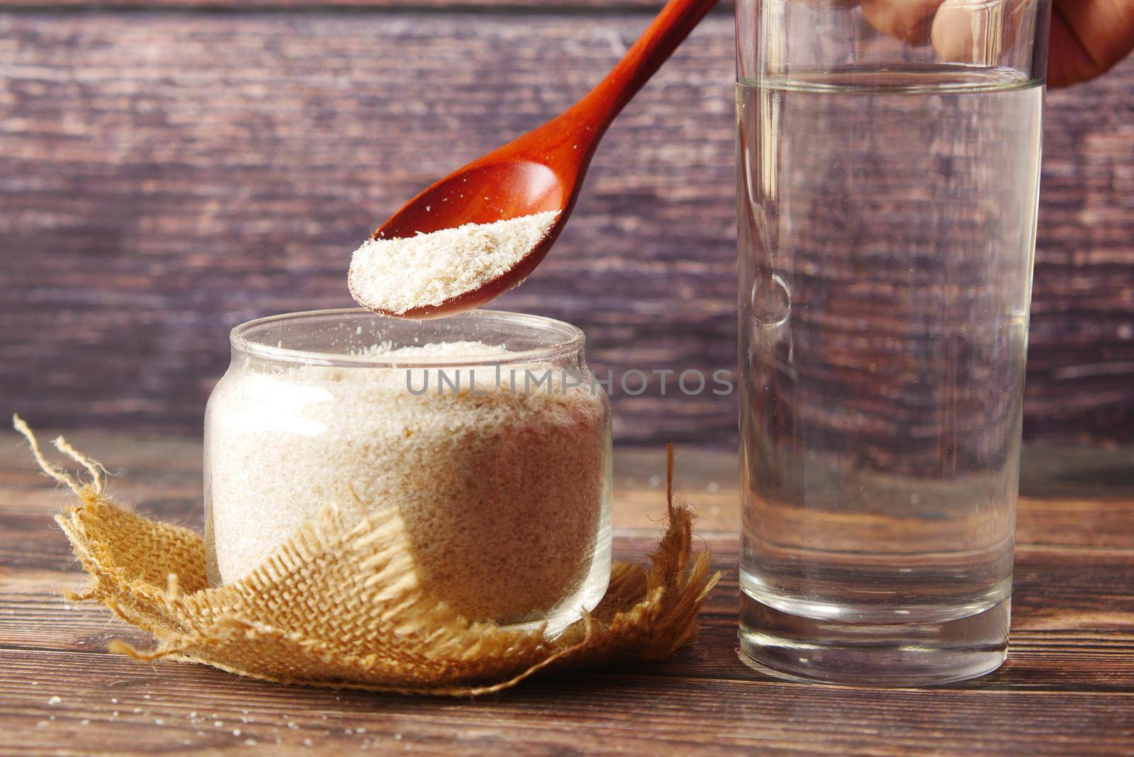 Wooden Spoon with Psyllium Seeds on dark background by towfiq007