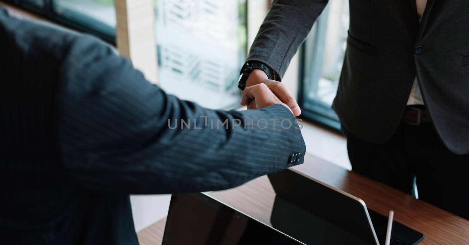 Businessman handshake for teamwork of business merger and acquisition,successful negotiate,hand shake,two businessman shake hand with partner to celebration partnership and business deal concept