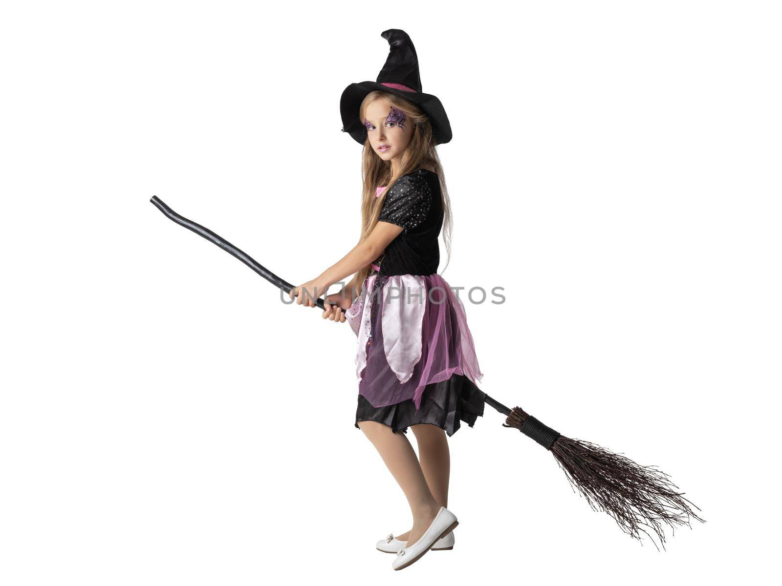 Halloween party witch girl on broom isolated on white background, adorable cute young kid acting to be witch in studio