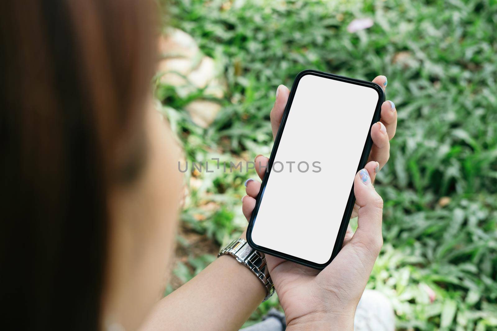 mockup image cell phone blank white screen for text. woman hand holding texting message chatting with friend by nateemee