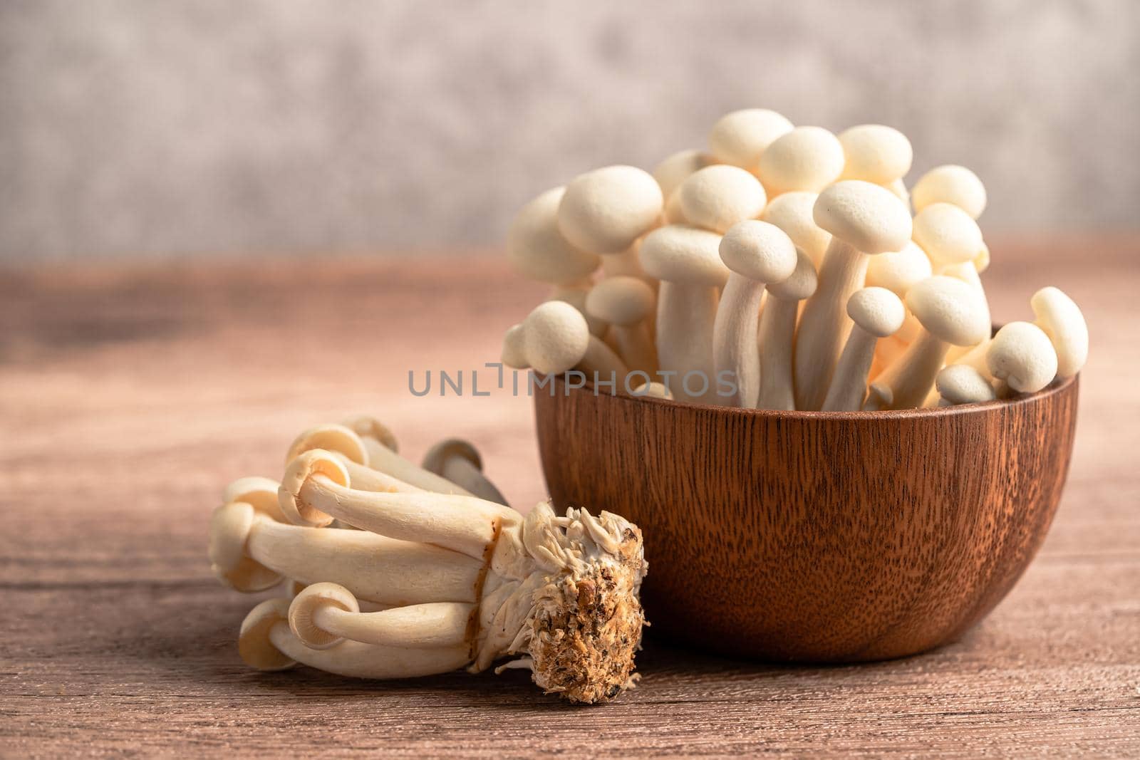 Shimeji, Fresh white bunapi mushrooms from Asia in wooden bowl.