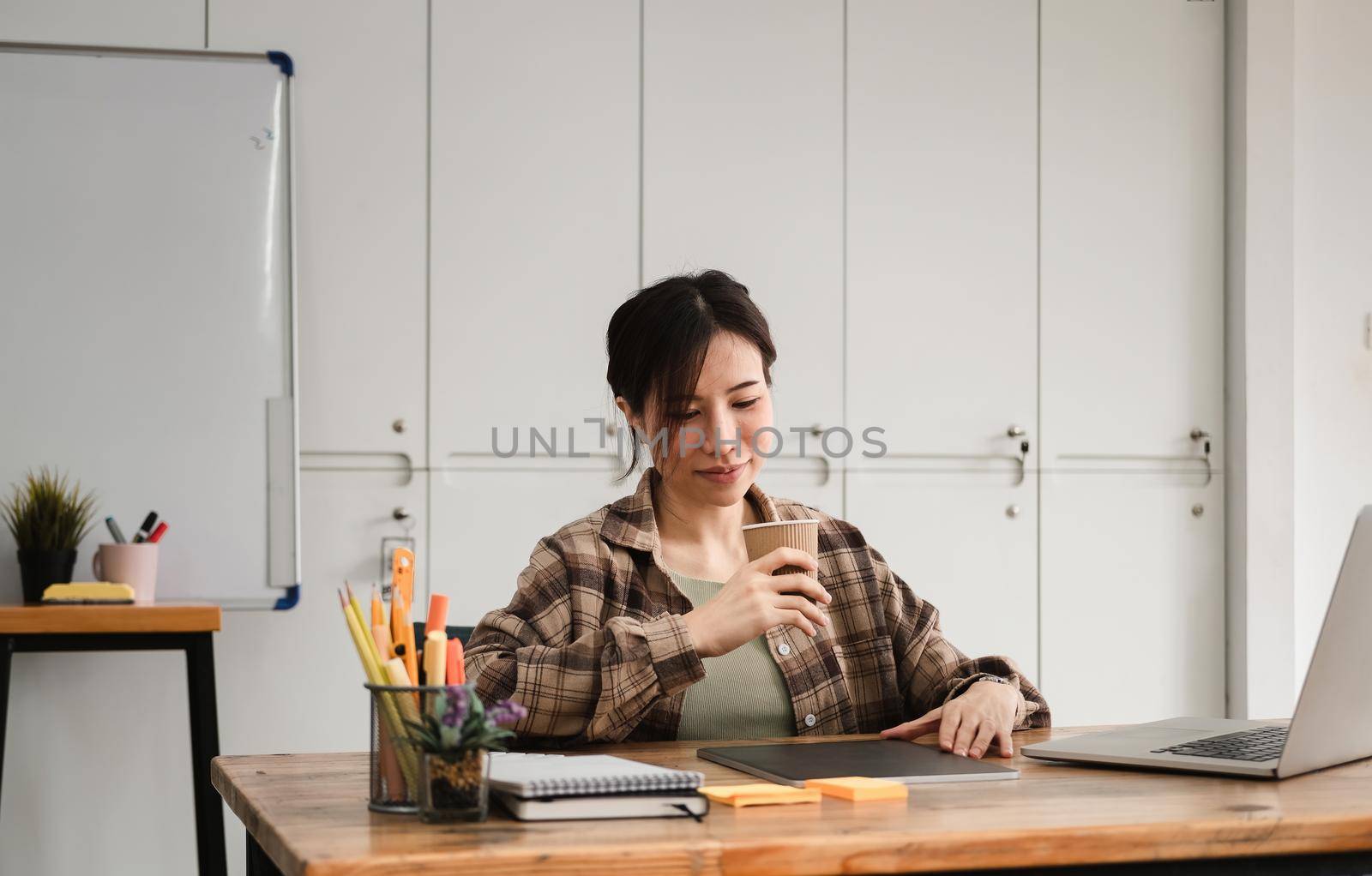 Cropped photo of asian woman working or learning on laptop indoors- educational course or training, seminar, education online concept by nateemee