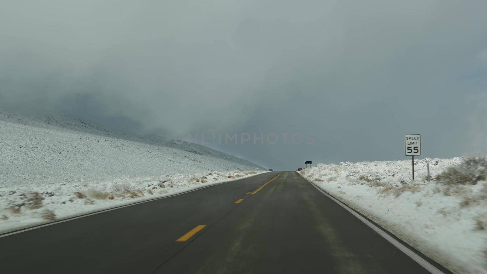 Road trip to Death Valley, driving auto, snow in California, USA. Hitchhiking winter traveling in America. Highway, mountain pass and dry barren wilderness. Passenger POV from car. Journey to Nevada by DogoraSun