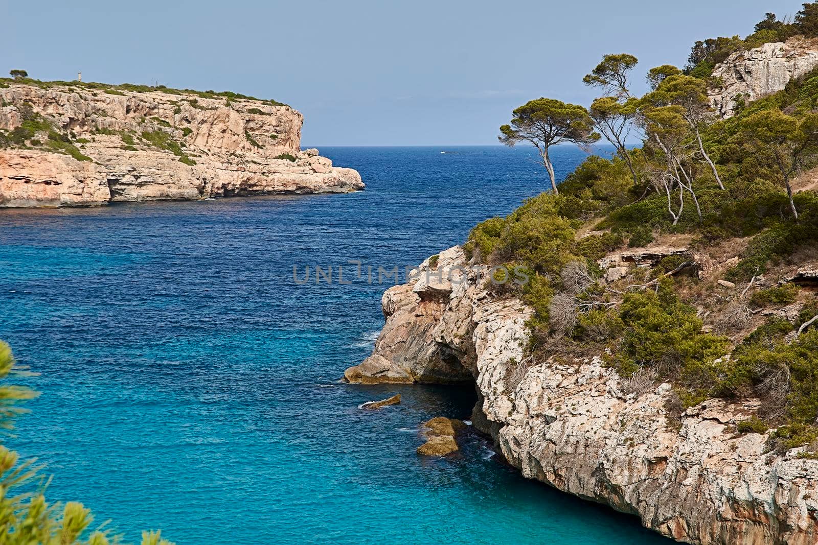 Paradise beach of the mediterranean sea, turquoise water, yes people, cliffs, rocks, white sand, Balearic Islands, Spain