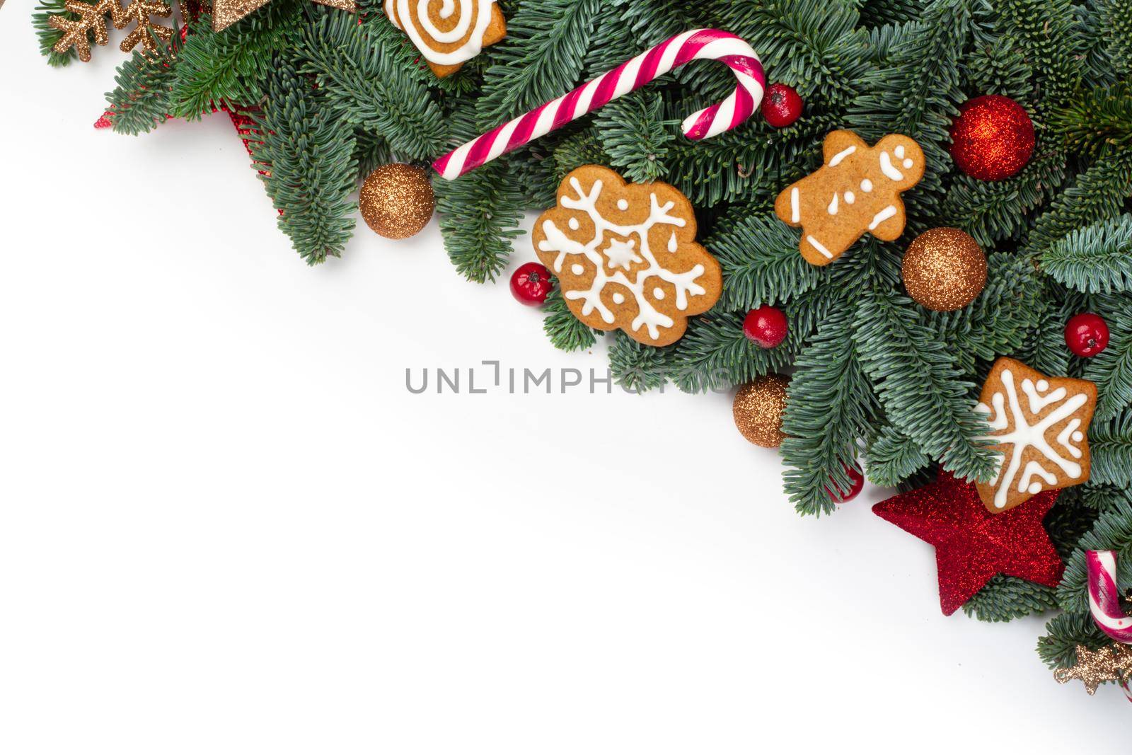 Christmas design boder frame greeting card of noble fir tree branches cookies and baubles isolated on white background