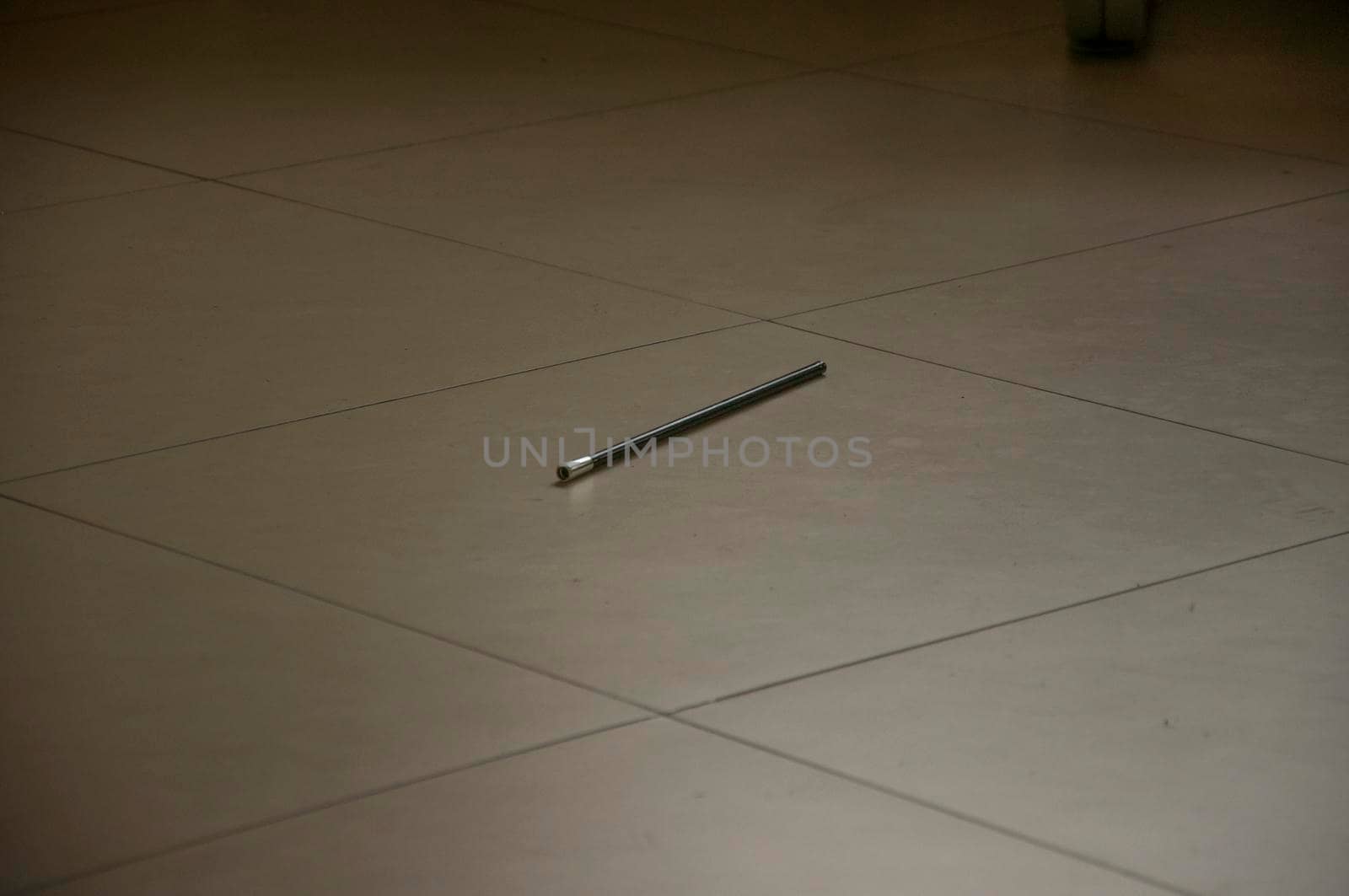 A black pencil on the floor. by inxti