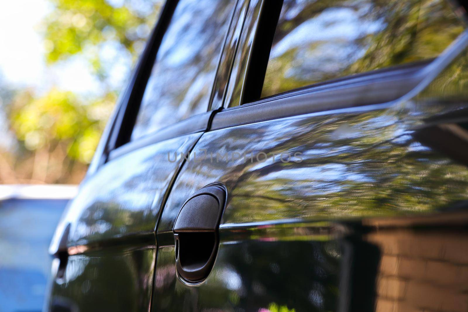 Car door handle with natural curved reflection detail transportation abstract close-up