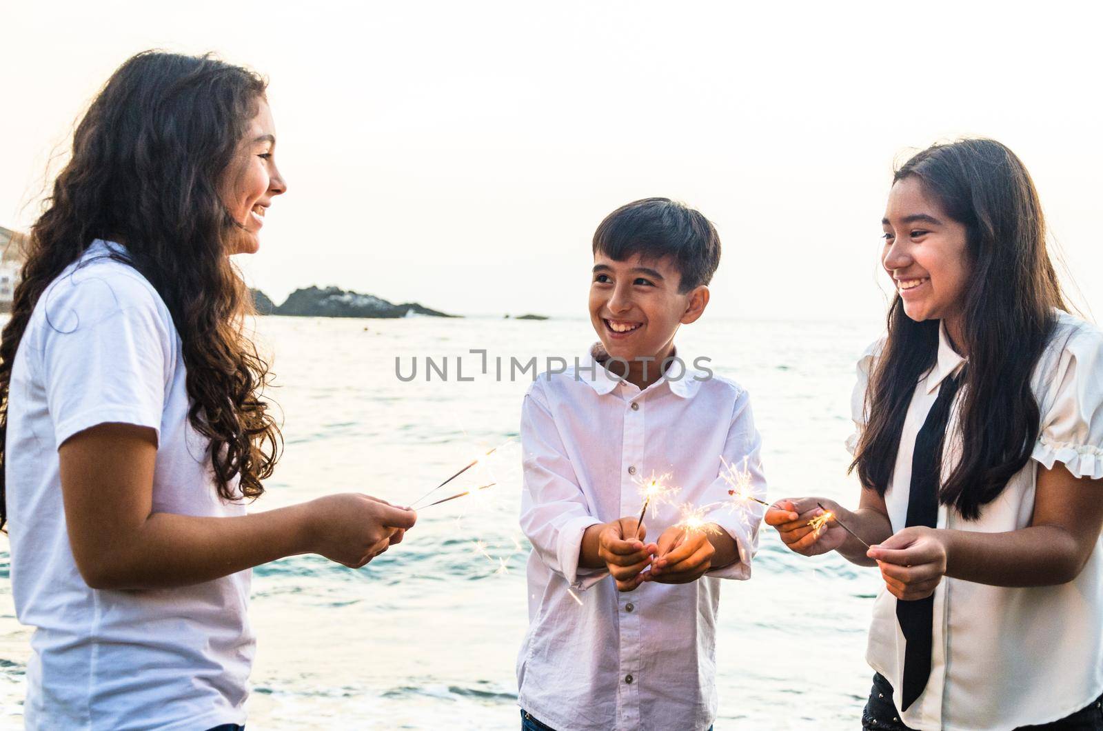 Happy children in party with burning sparkler in his hand. Creative invitation for party, holiday, wedding, birthday, christmas, New Year concept.