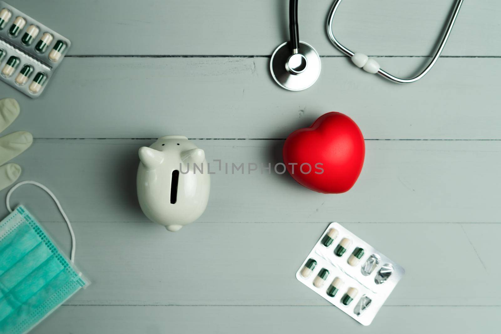 World health day concept and Healthcare medical insurance with red heart and medical instrument on wooden background by psodaz