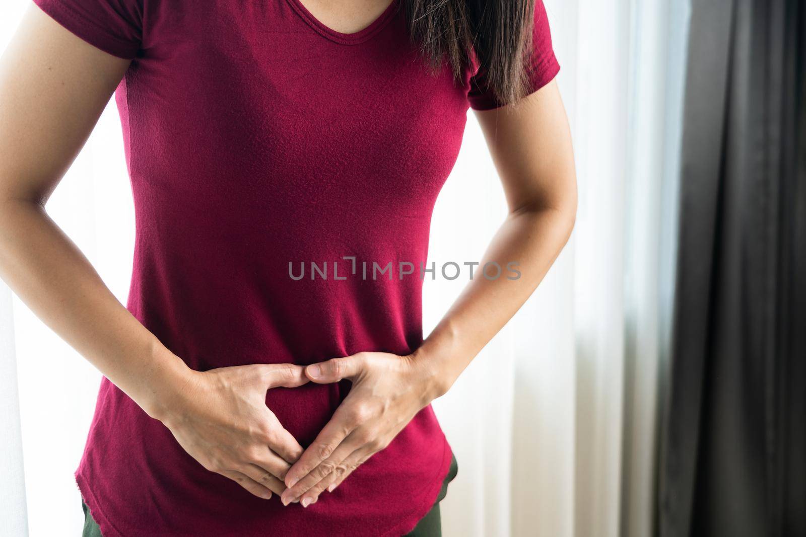 woman having painful stomachache at home. Chronic gastritis. Abdomen bloating concept