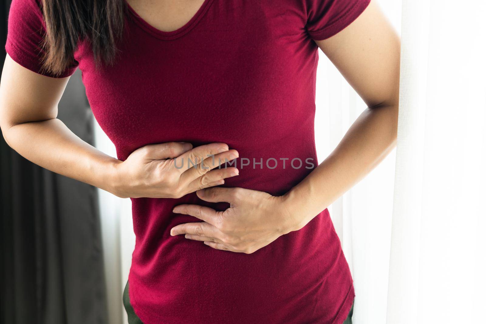 woman Suffering From Acid Reflux Or gastroesophageal reflux at home