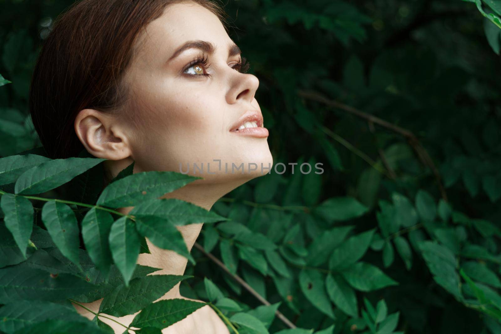 attractive woman green leaves clean skin nature summer Lifestyle. High quality photo