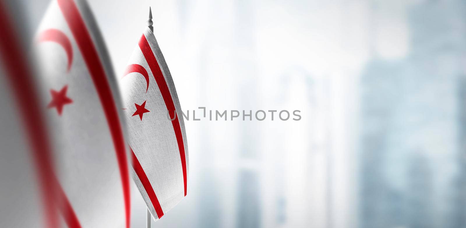 Small flags of Northern Cyprus on a blurry background of the city.