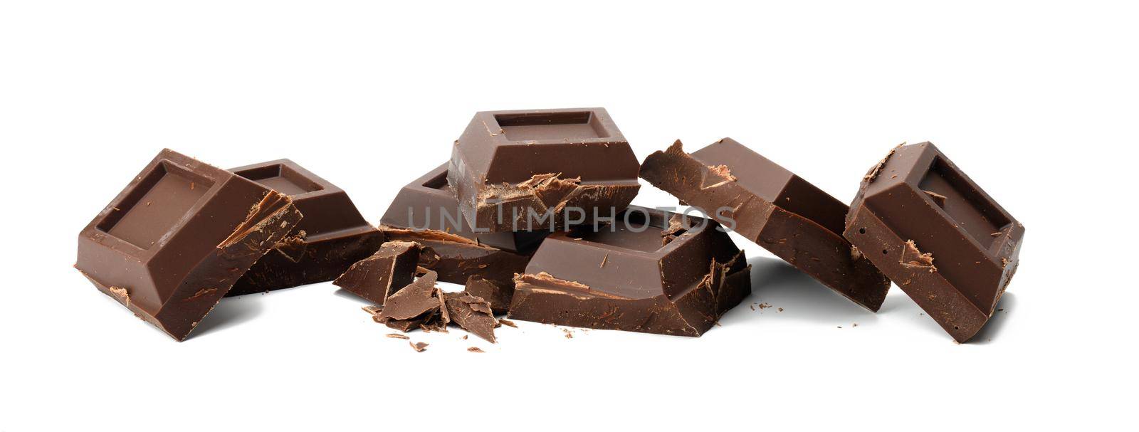 broken black chocolate with pieces isolated on white background. Dessert bar of chocolate, close up