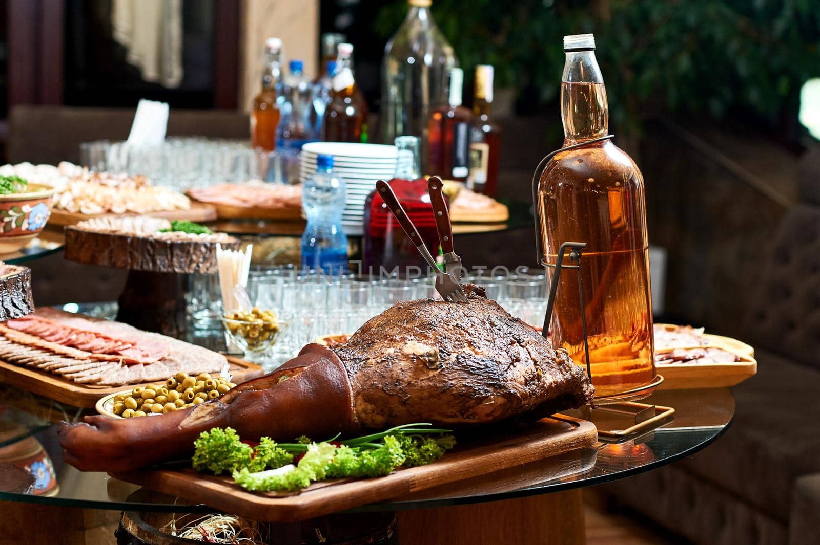 Smoked pork leg on the restaurant table by SerhiiBobyk