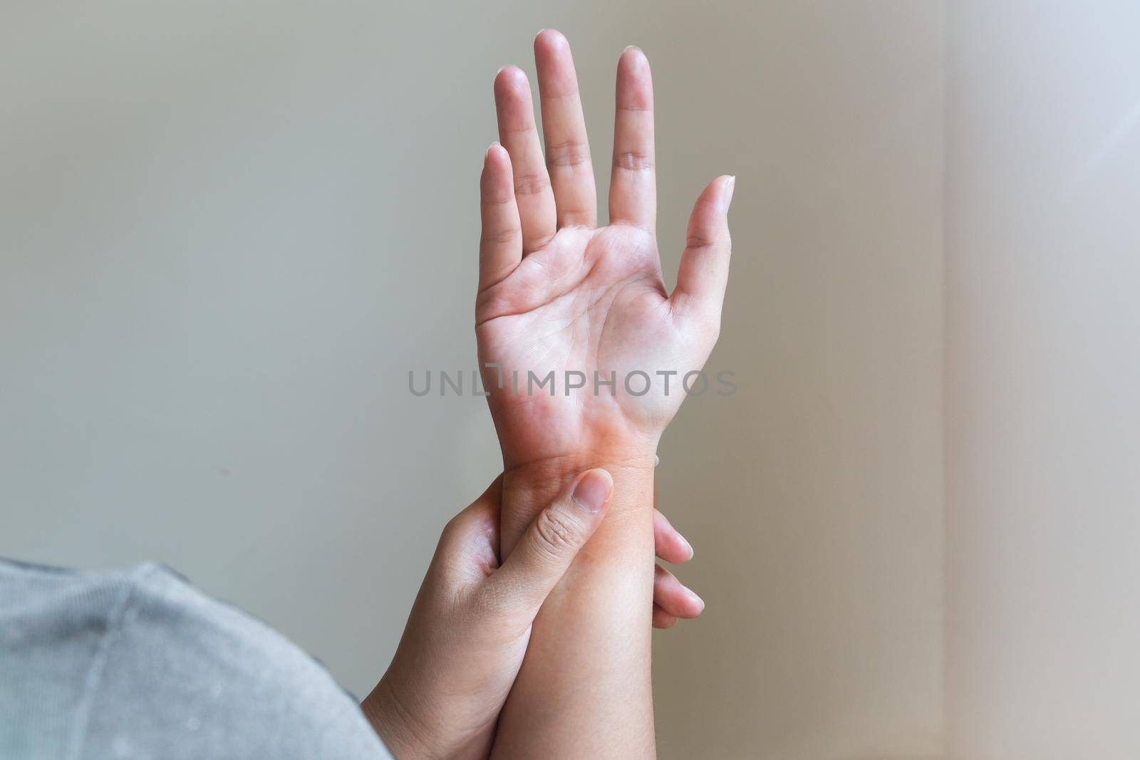 Woman massaging her painful hand. Healthcare and medical concept.