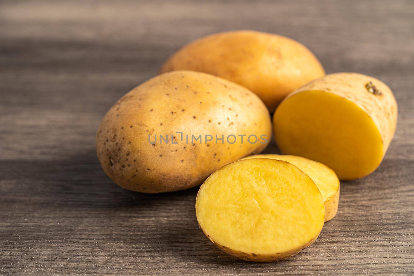 Potato raw and fresh vegetable food on wooden background.