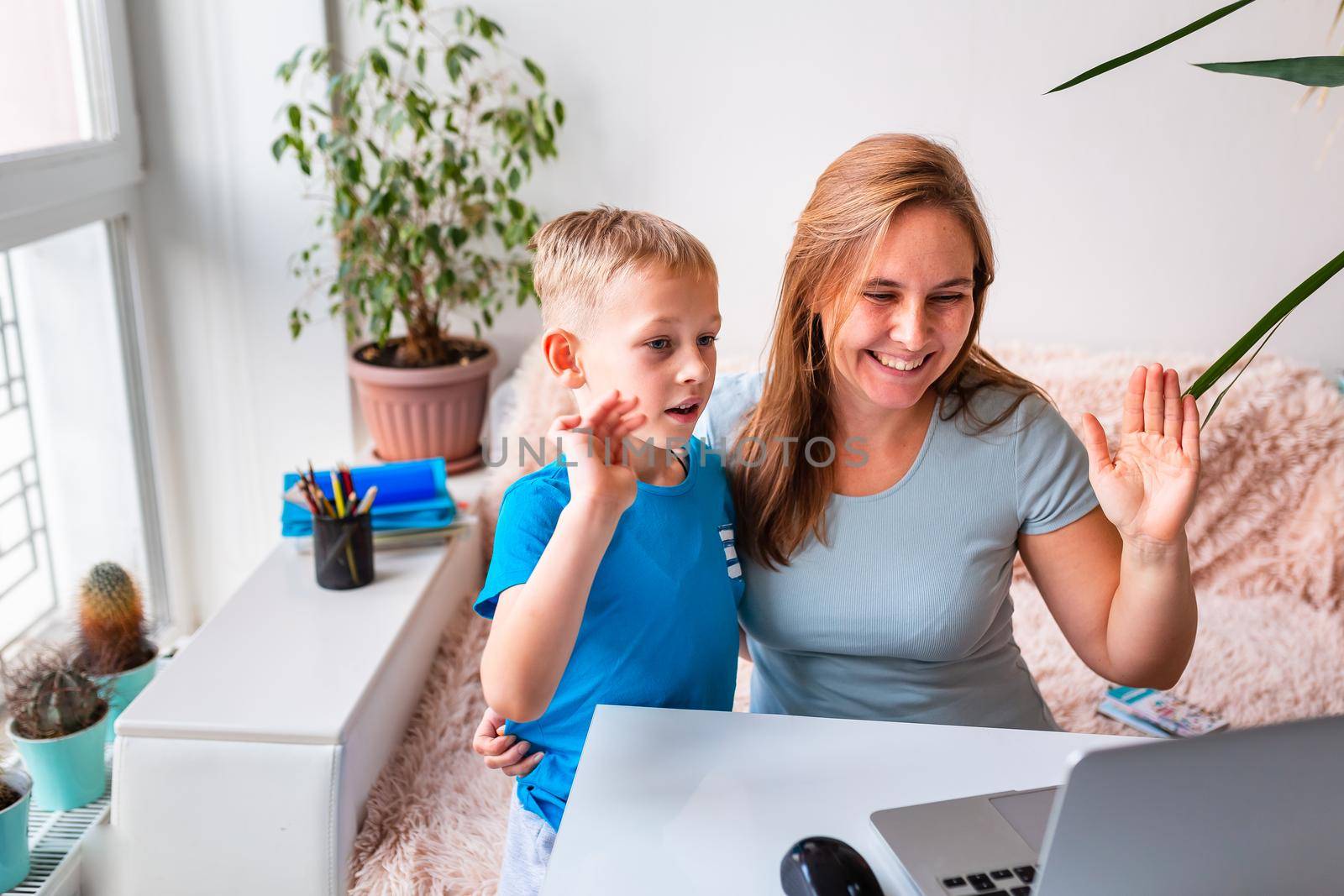 Mother with kid trying to work from home during quarantine. Stay at home, work from home concept during coronavirus pandemic