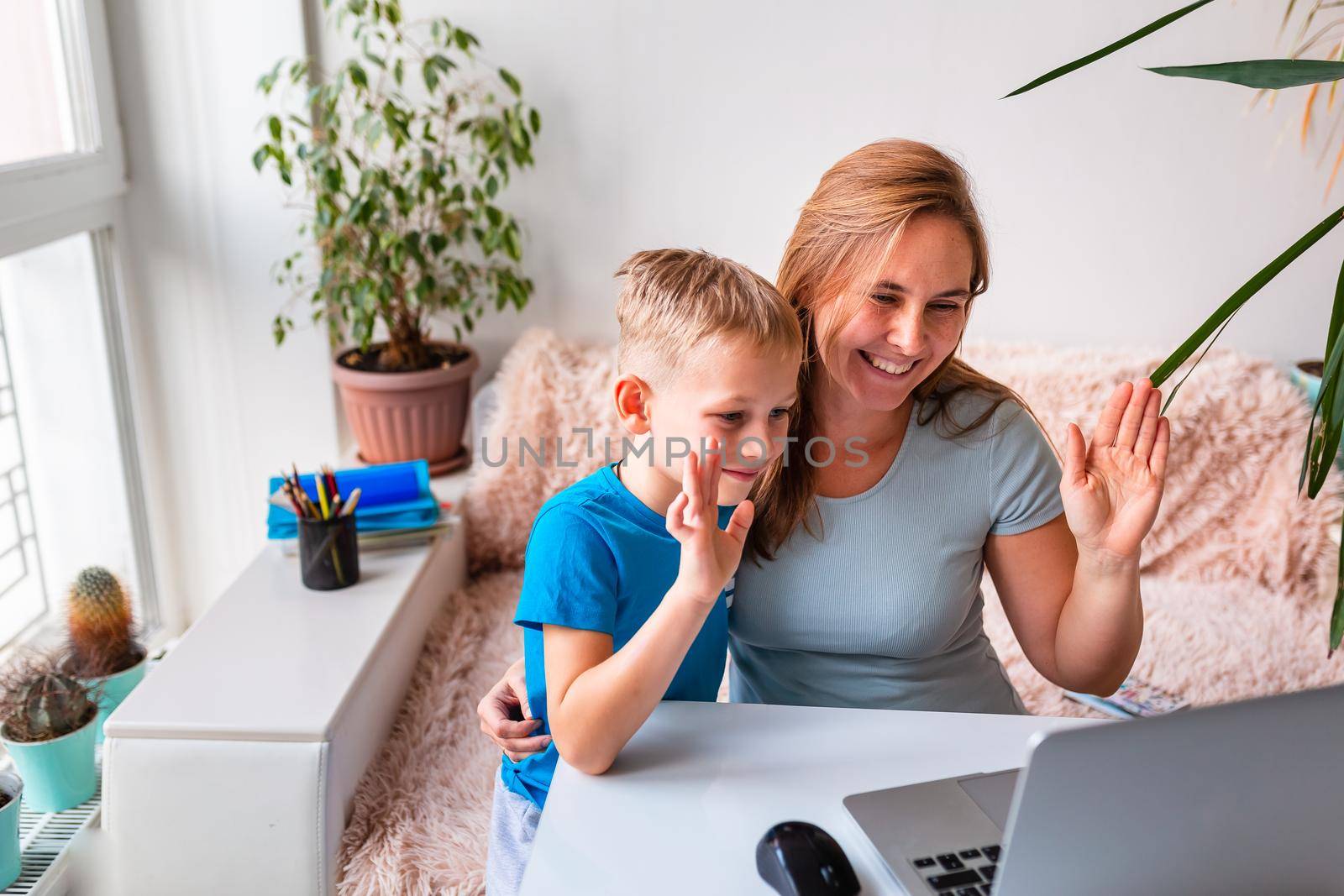 Mother with kid trying to work from home during quarantine. Stay at home, work from home concept during coronavirus pandemic