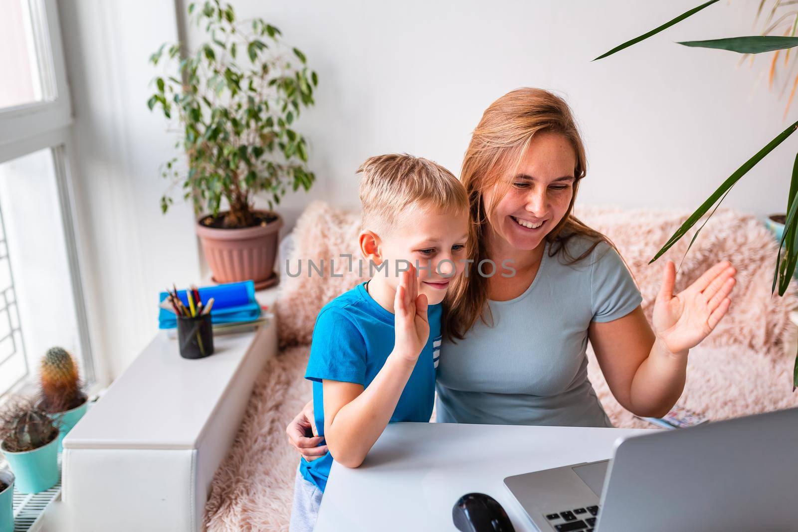 Mother with kid trying to work from home during quarantine. Stay at home, work from home concept during coronavirus pandemic