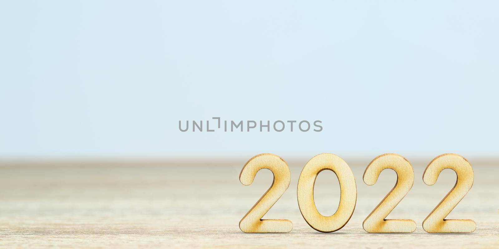 Wooden numeric new year 2022 on table with copy space