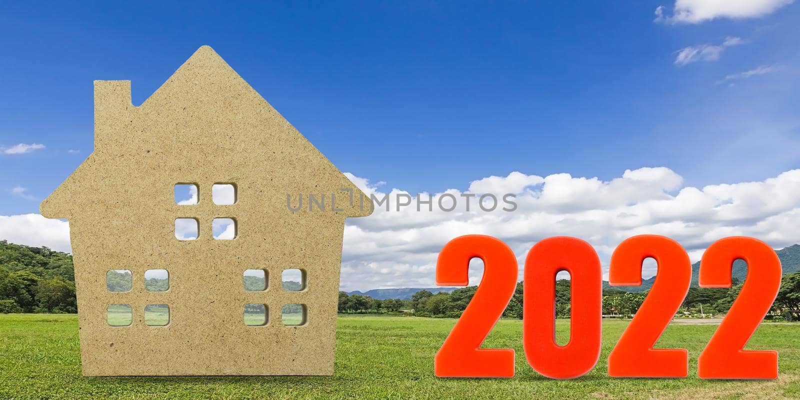 House model and number 2022 with landscape back background for finance and banking concept