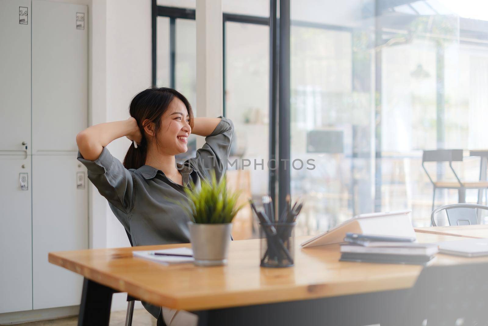 Business woman relaxing in chair after hard work at offlice
