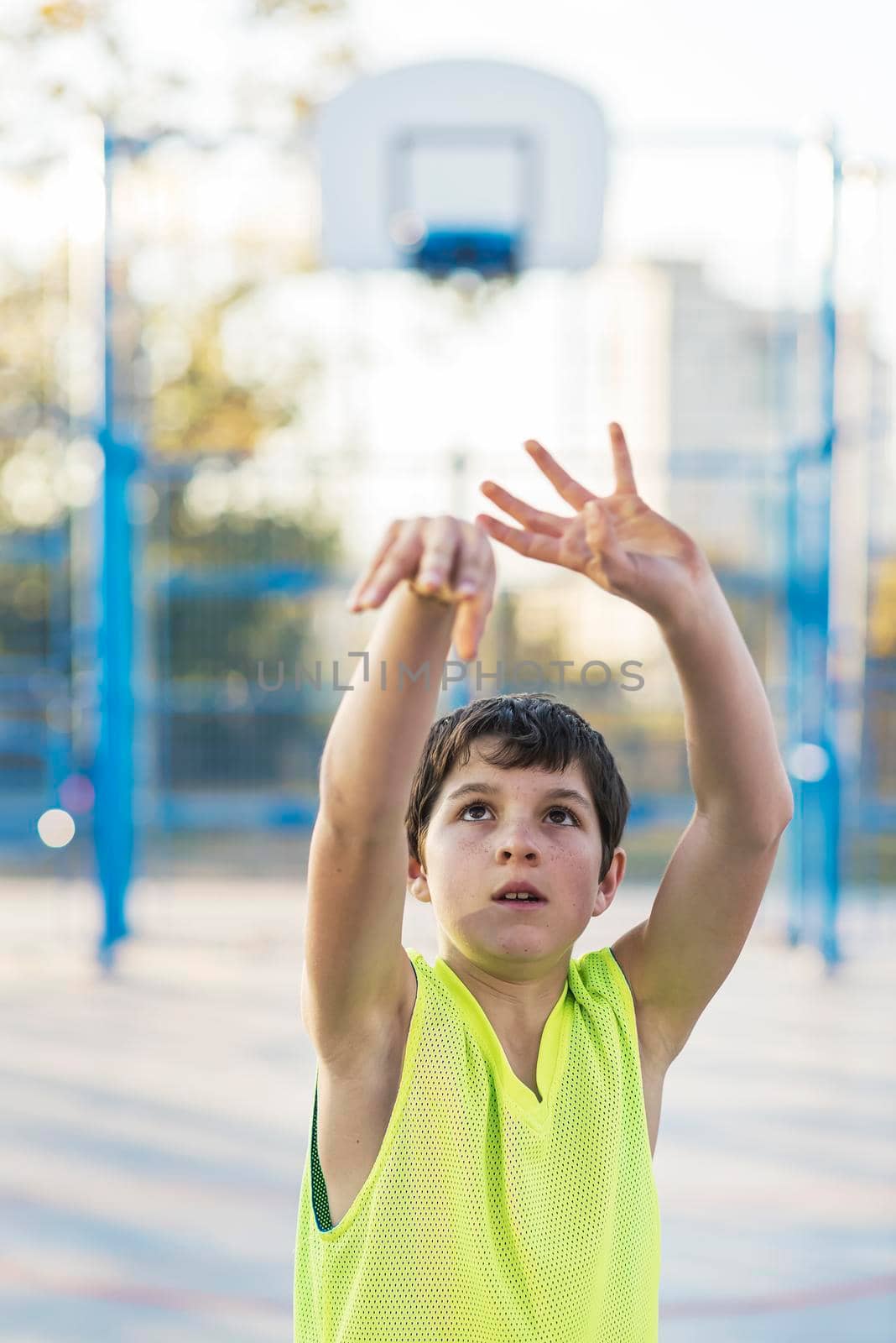 A Teenage playing basketball on an outdoors court