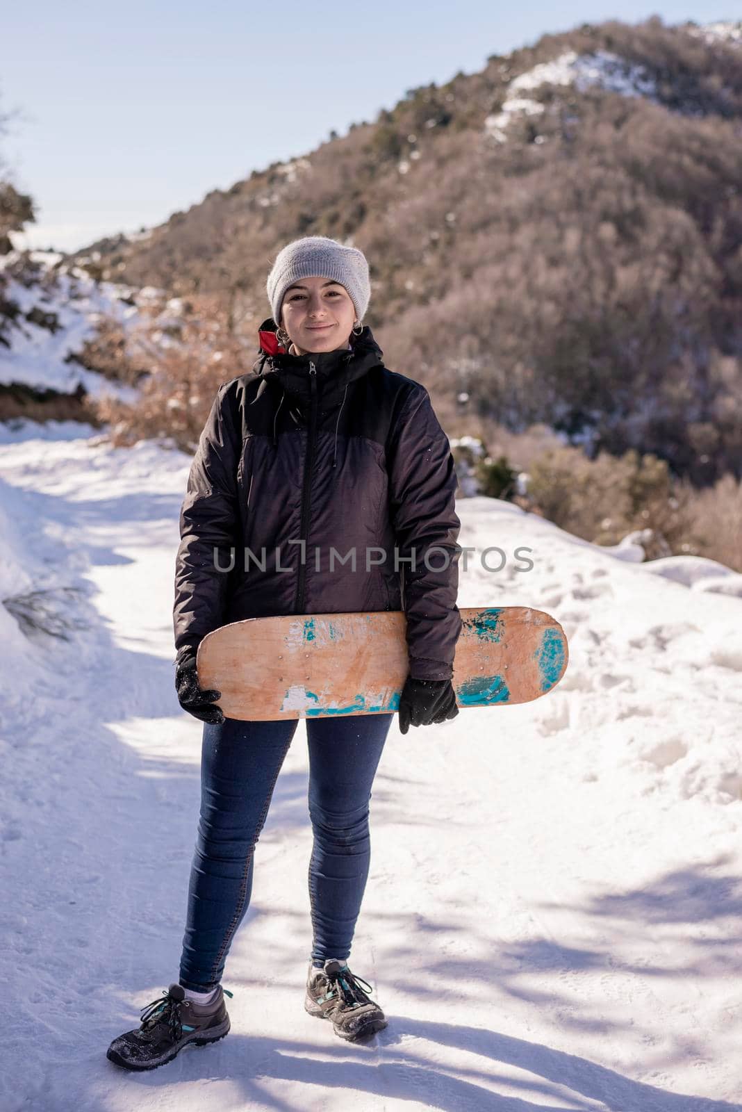 Young woman in snowy mountains at sunset in winter. by raferto1973