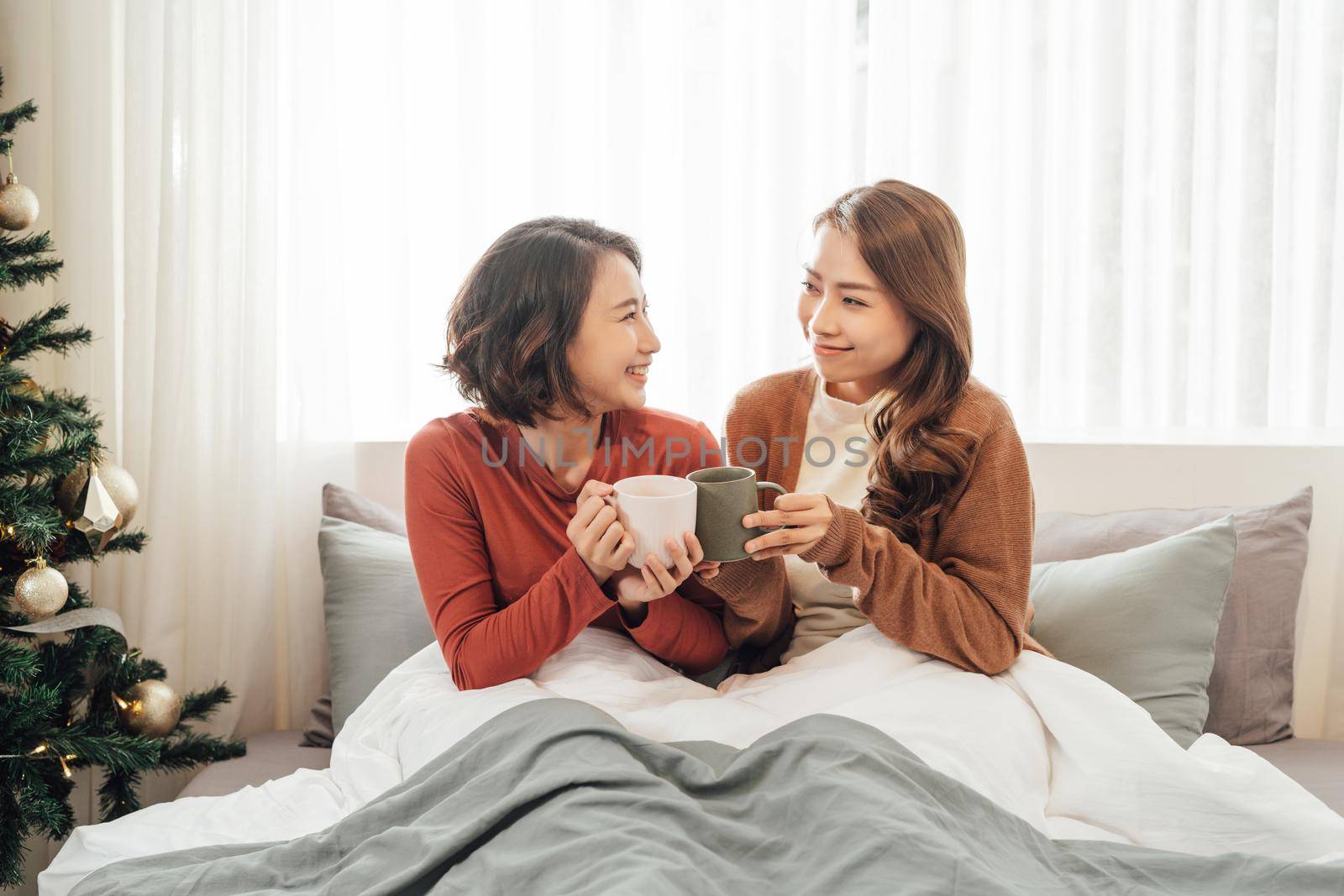 Two friends drinking coffee at home