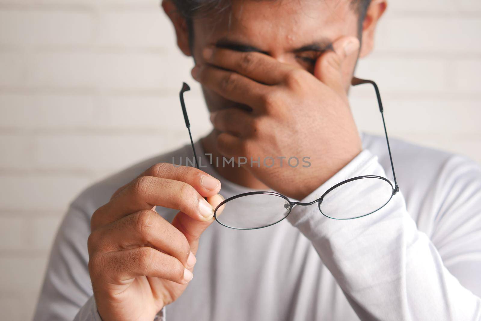 Close up of upset man suffering from strong eye pain by towfiq007