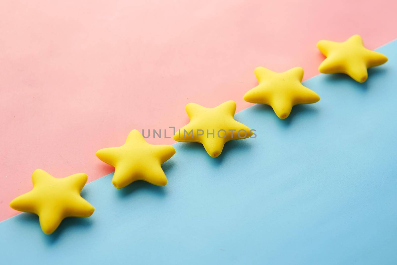 Customer review concept. Rating golden stars on blue background .