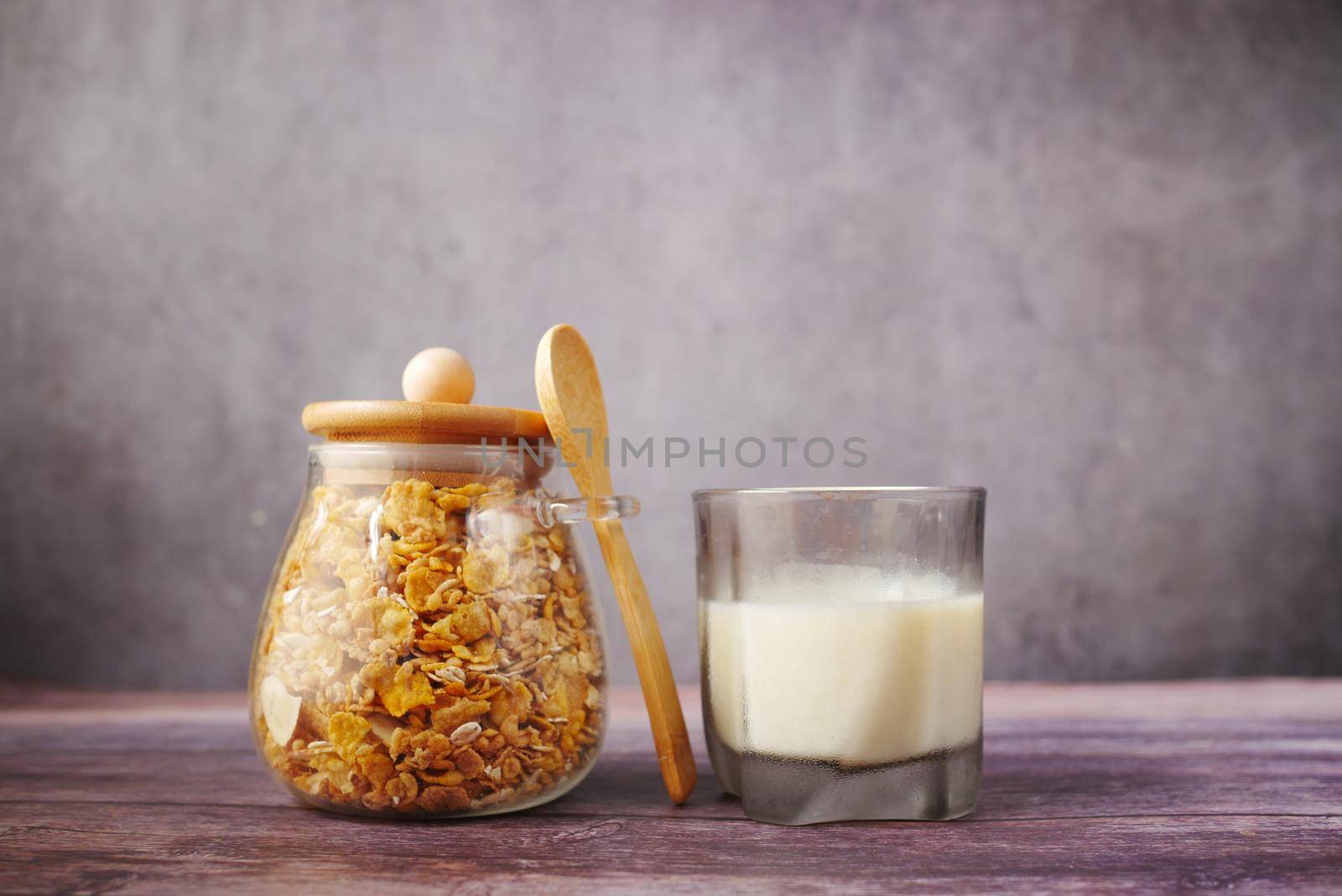 Home Made Musli in a bowl and glass of milk on black, by towfiq007