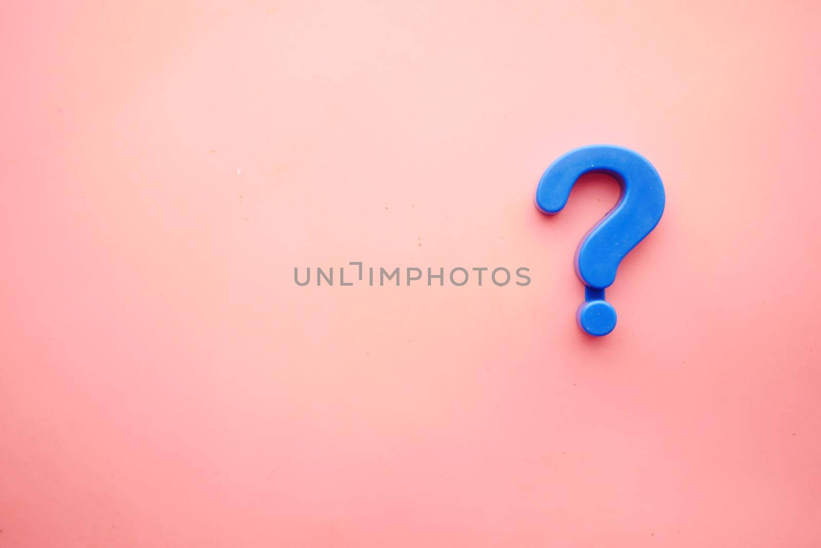 question mark on a pink background with copy space .