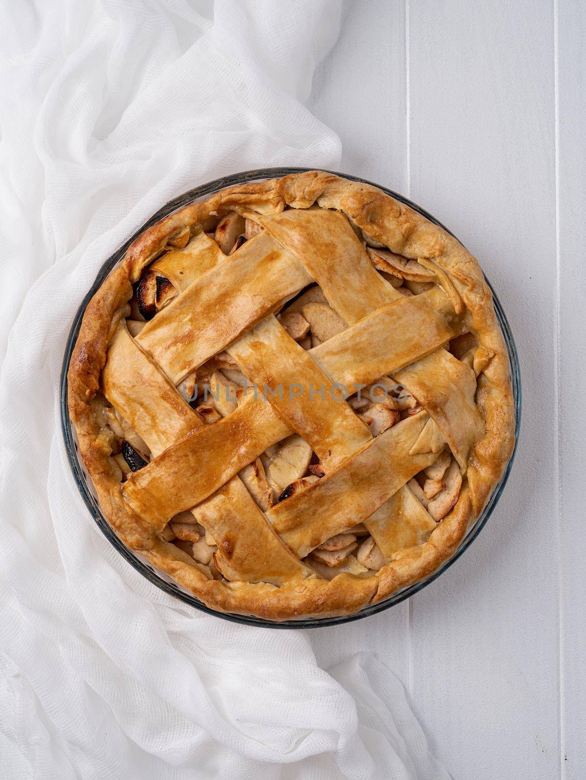 Autumn foods. Top view of homemade apple pie on white wooden table, minimal style