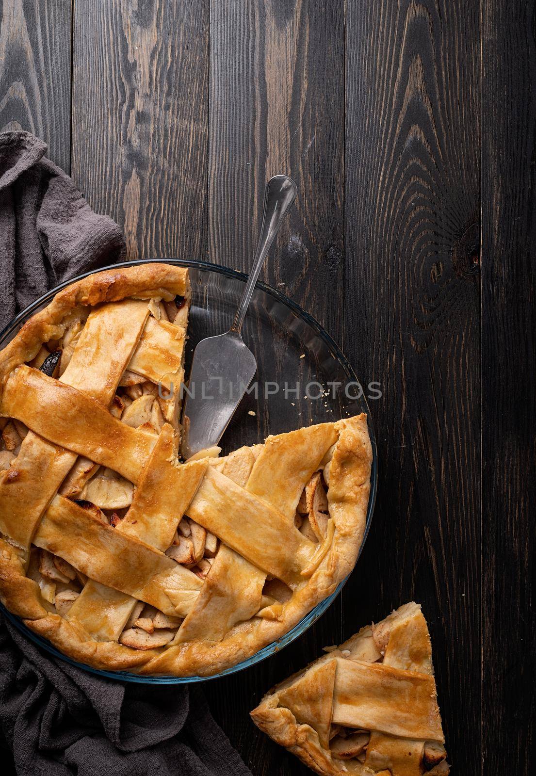 Autumn foods. Top view of homemade apple pie on dark wooden table