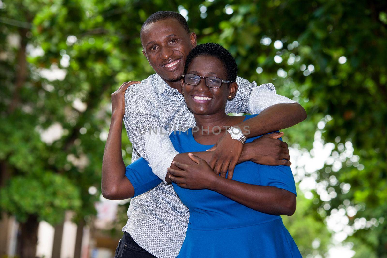 young african couple embracing while looking at each other smiling.